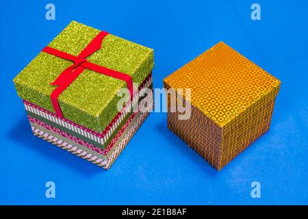 Two Christmas Gift Boxes On Blue Background Stock Photo
