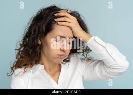 Tired frustrated business woman office worker sighing wiping sweat of forehead has emotional burnout Stock Photo