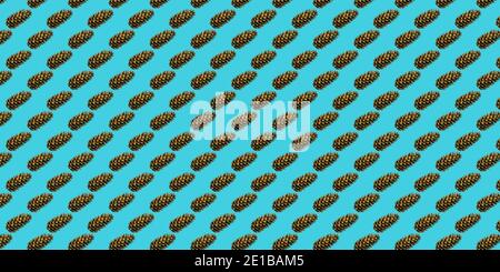 Seamless Christmas pattern of fir cones on a blue background. Printing on paper, fabric, Wallpaper. Stock Photo