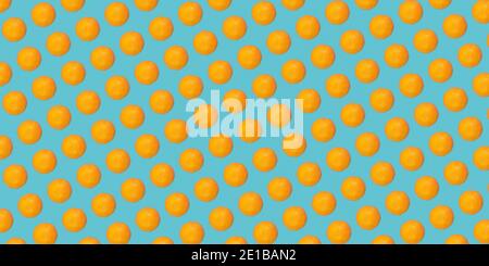 Seamless fruit pattern of fresh tangerines on a blue background. Print, design, creative summer concept. Stock Photo