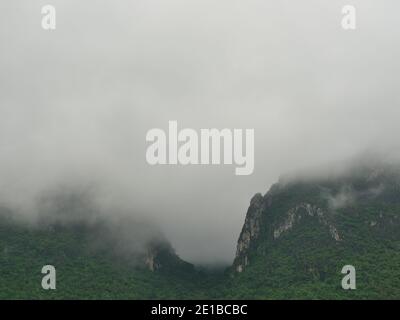 Cloud and fog cover limestone mountain in the rainy season, Green forest and rock at Khao Sam Roi Yot National Park, Thailand Stock Photo