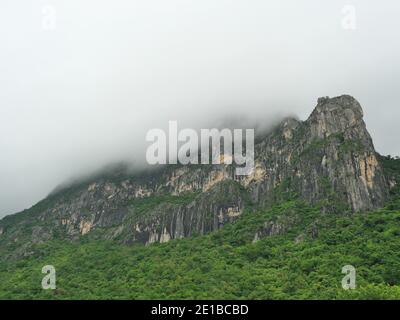 Cloud and fog cover limestone mountain in the rainy season, Green forest and rock at Khao Sam Roi Yot National Park, Thailand Stock Photo