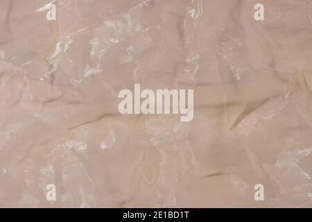 Beige crumpled organza fabric. Abstract background. Stock Photo