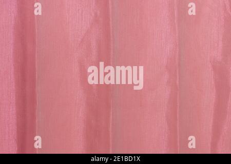 Red crumpled fabric close up. Abstract background. Stock Photo