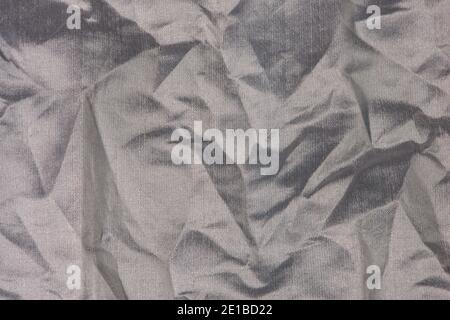 Silver crumpled fabric close up. Abstract background. Stock Photo