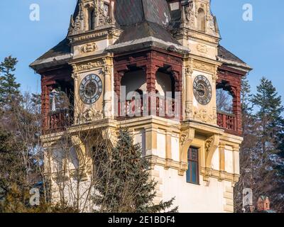 Sinaia Romania - 12.02.2020: Architecture detail with one of the Peles Castle towers. Castle tower with a clock. Stock Photo