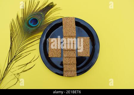 Til sakri or Tilgul an Indian traditional popular sweet made out of Sesame seeds and jaggery melted and set in to sheets and cut. Famous Sankranti fes Stock Photo