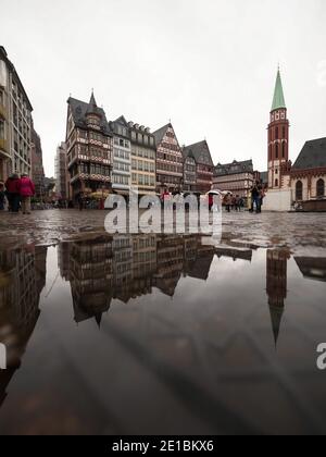 Puddle mirror pond reflection of traditional half-timbered old houses buildings on Romer square Frankfurt am Main Hesse Germany Europe Stock Photo