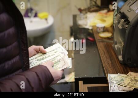 December 22, 2020, Gaziantep, Southeast Anatolia, Turkey: Gaziantep, Turkey. A money changer employee counts US dollar banknotes in different denominations at a Bureau de Change store in Gaziantep, Turkey. The US dollar banknotes are currently issued in $1, $2, $5, $10, $20, $50, and $100 notes by the USA's Federal Reserve (Credit Image: © Muhammad Ata/IMAGESLIVE via ZUMA Wire) Stock Photo