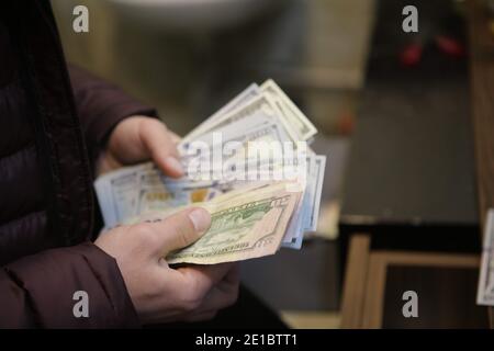 December 22, 2020, Gaziantep, Southeast Anatolia, Turkey: Gaziantep, Turkey. A money changer employee counts US dollar banknotes in different denominations at a Bureau de Change store in Gaziantep, Turkey. The US dollar banknotes are currently issued in $1, $2, $5, $10, $20, $50, and $100 notes by the USA's Federal Reserve (Credit Image: © Muhammad Ata/IMAGESLIVE via ZUMA Wire) Stock Photo