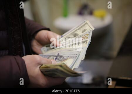 December 22, 2020, Gaziantep, Southeast Anatolia, Turkey: Gaziantep, Turkey. A money changer employee counts US dollar banknotes in different denominations at a Bureau de Change store in Gaziantep, Turkey. The US dollar banknotes are currently issued in $1, $2, $5, $10, $20, $50, and $100 notes by the USA's Federal Reserve (Credit Image: © Muhammad Ata/IMAGESLIVE via ZUMA Wire) Stock Photo