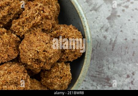 Top close view of a bowl filled with gluten free chocolate macaroons on a gray background. Stock Photo