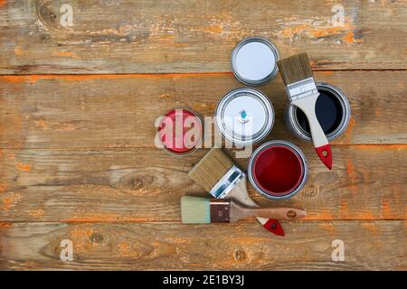 Paint cans and brushes on the old wooden background. Concept of house renovation Stock Photo