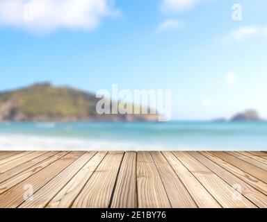 Wooden platform with blurred background of sea and hills. Deck ready for put product in display. Stage for objects presentation with copy space. Stock Photo
