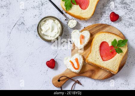 Breakfast for valentine's day or mother's day, toast with salmon and curd cheese with the inscription that I love you.Top view flat lay. Copy space. Stock Photo