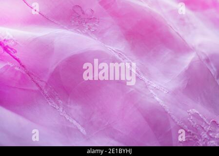 Pink background from a transparent organza with embroidery with pink threads to match. Stock Photo