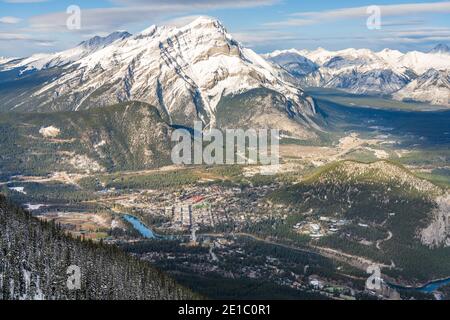 Overlook view Town of Banff, Cascade Mountain and surrounding snow-covered Canadian Rocky Mountains in early winter time. Banff National Park, Alberta Stock Photo