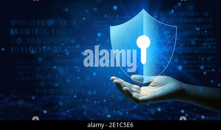 Antivirus shield icon with Keyhole on hand of businessman using Cyber Security Privacy or Information Privacy to block a cyber attack. Stock Photo