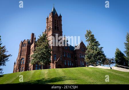 Crouse College sits atop a green grassy hill on the campus of Syracuse University in Syracuse, New York. Stock Photo