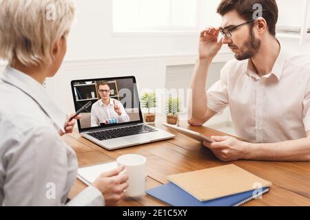 Colleagues Video Calling At Laptop Having Virtual Business Meeting Indoor Stock Photo