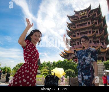 Beijing, China's Hubei Province. 7th Aug, 2020. Chen Xiaomei (L) and Ji Chao, once members of the medical assistance team from Hainan, visit Yellow Crane Tower in Wuhan, central China's Hubei Province, Aug. 7, 2020. The province invited medical staff who had assisted Hubei during the COVID-19 outbreak, as well as local medical workers, community workers and volunteers, to visit its tourist attractions. Credit: Xiao Yijiu/Xinhua/Alamy Live News Stock Photo