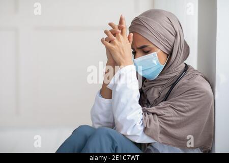 Tired muslim woman doctor having short break during working shift Stock Photo