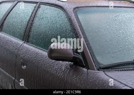 Icy car rearview mirror, windshield, car with icicles, ice close-up. Frozen car Stock Photo