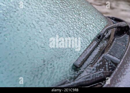 Icy car windshield close-up. Icy windshield, wipers of the car close up Stock Photo