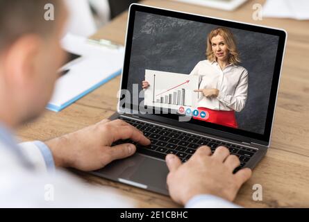 Businessman Having Meeting With Colleague Video Calling Via Laptop Indoor Stock Photo