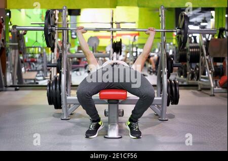 Young Man Doing Bench Press Workout In Gym. High quality photo Stock Photo