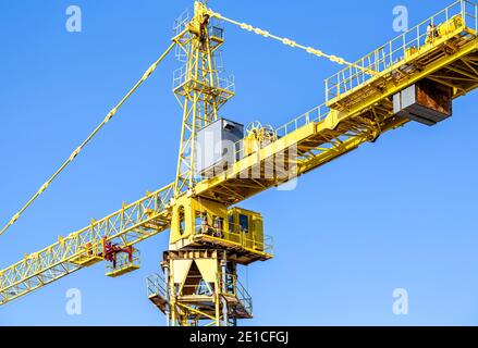 Construction tower crane against the blue sky background Stock Photo