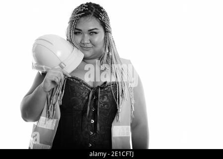 Young fat Asian construction woman holding safety helmet near the face Stock Photo