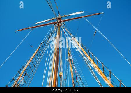 Old sailing ship wood mast, rigging of a sailing ship detail Stock Photo