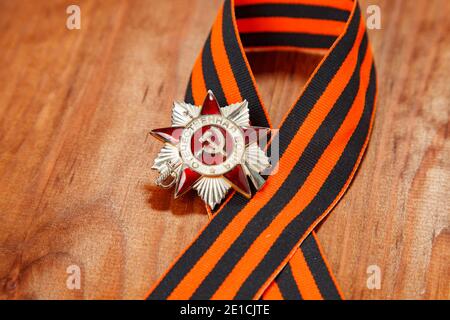 Order of the Patriotic War in St. George's Ribbon on a wooden background Stock Photo