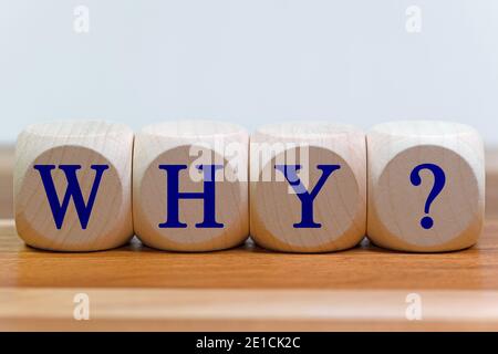 Wooden cubes with the inscription WHY and question mark Stock Photo