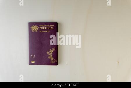 Overhead shot of Portuguese passport isolated on wooden table. European passport  Stock Photo