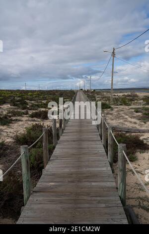 An endless long wooden boardwlk in the Ria Formosa National Park on the Algarve Stock Photo