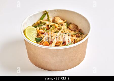 Pad thai noodle cube with chicken zucchini and cashew nuts isolated on white background. Stock Photo