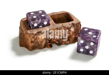 Pair of purplse stone dice with wooden holder designed by Anna Rabinowicz photographed on a white background Stock Photo