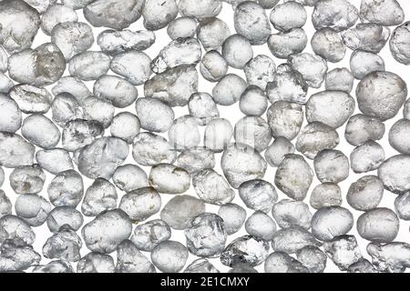 Macro image of grains of Wanipigow White Sand photographed at 5x magnification on a white background. Stock Photo