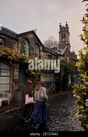 The famous Circus Lane, in Stockbridge area of Edinburgh, Scotland. Winter of 2020. fashionable friends walking Stock Photo