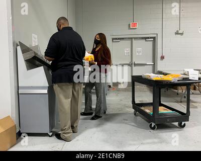 Lawrenceville, Georgia, USA. 6th Jan, 2021. Mail-in absentee ballots have been sorted into their precincts, marked by the numbered marigold sheets, and are being prepared for the next steps in processing. Credit: Sue Dorfman/ZUMA Wire/Alamy Live News Stock Photo