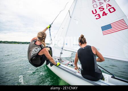 Womens sailing team Perfect Vision Sailing training together in Newport Harbor as part of their hopeful Olympic 470 Campaign Stock Photo