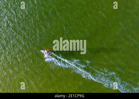 A windsurfer sails across the Noosa River, Queensland, Australia Stock Photo