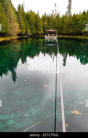 A view of Kitch-iti-kipi, Michigan's largest natural freshwater spring. The name means big cold water and is sometimes referred to as The Big Spring. Stock Photo