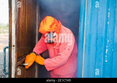 workers in the offshore industry practice escaping from a smoke chamber as part of an industry training course, that all offshore workers are required Stock Photo