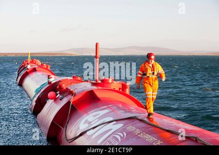 A Pelamis P2 wave energy generator on the dockside at Lyness on Hoy, Orkney Isles, Scotland, UK. The Orkney's have huge potential for wave and tidal e Stock Photo