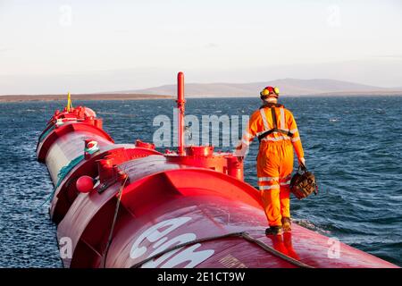A Pelamis P2 wave energy generator on the dockside at Lyness on Hoy, Orkney Isles, Scotland, UK. The Orkney's have huge potential for wave and tidal e Stock Photo