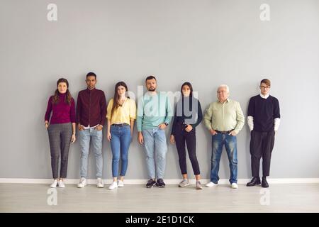 Team of startups consisting of people of different ages and nationalities stands in a row. Stock Photo