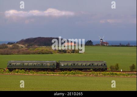 Class 101 DMU 51228/56062 passing Weybourne windmill on the North Norfolk Railway, England Stock Photo